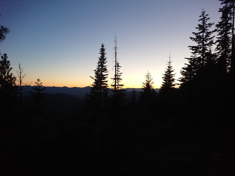 Sun below the mountains in the darkness