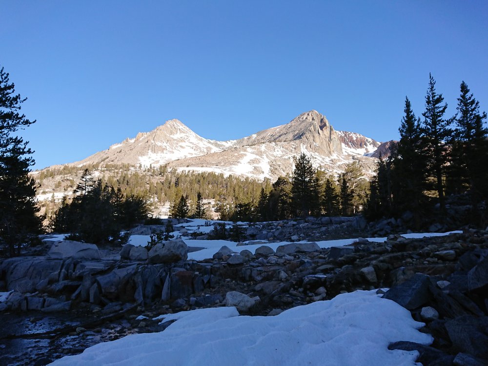 Morning sun illuminating some mountains in the distance.